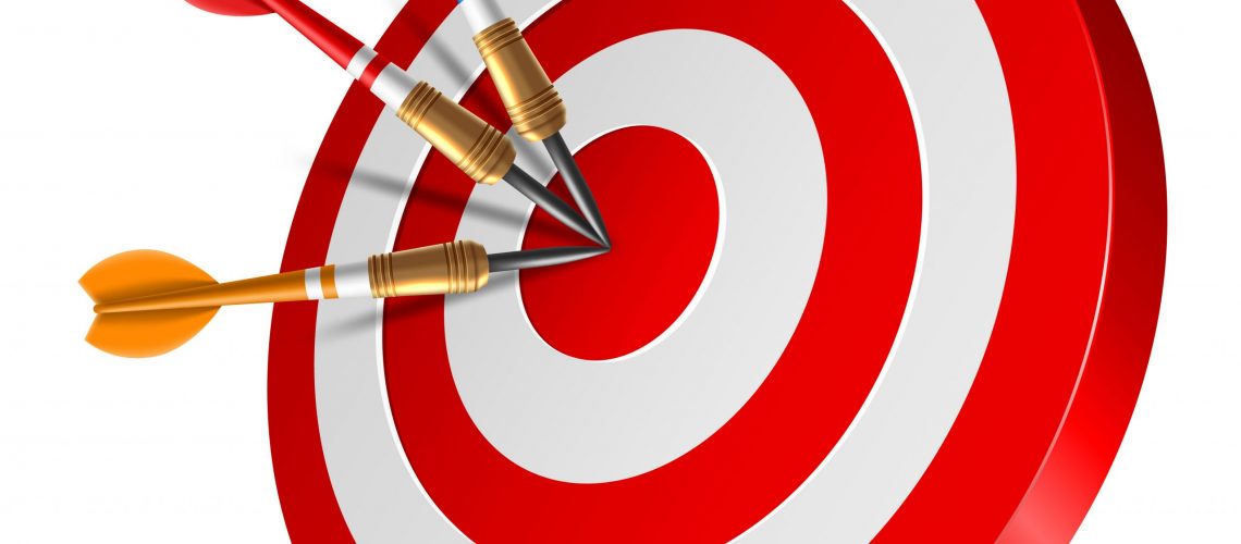 Red dart arrow hitting in the target center of dartboard